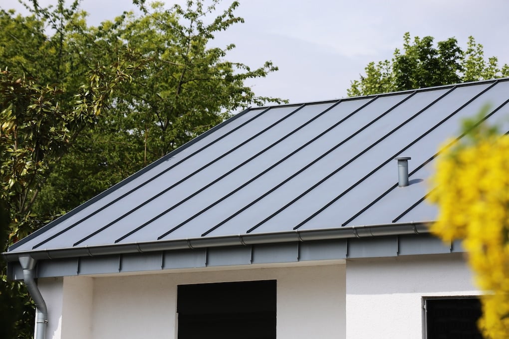 Metal standing seam roof on a residential home showing minimum pitch for metal roof