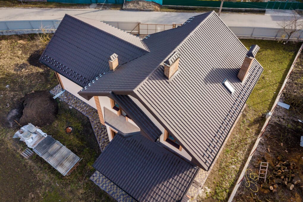 Aerial top view of metal roof on residential home; howl long does a metal roof last