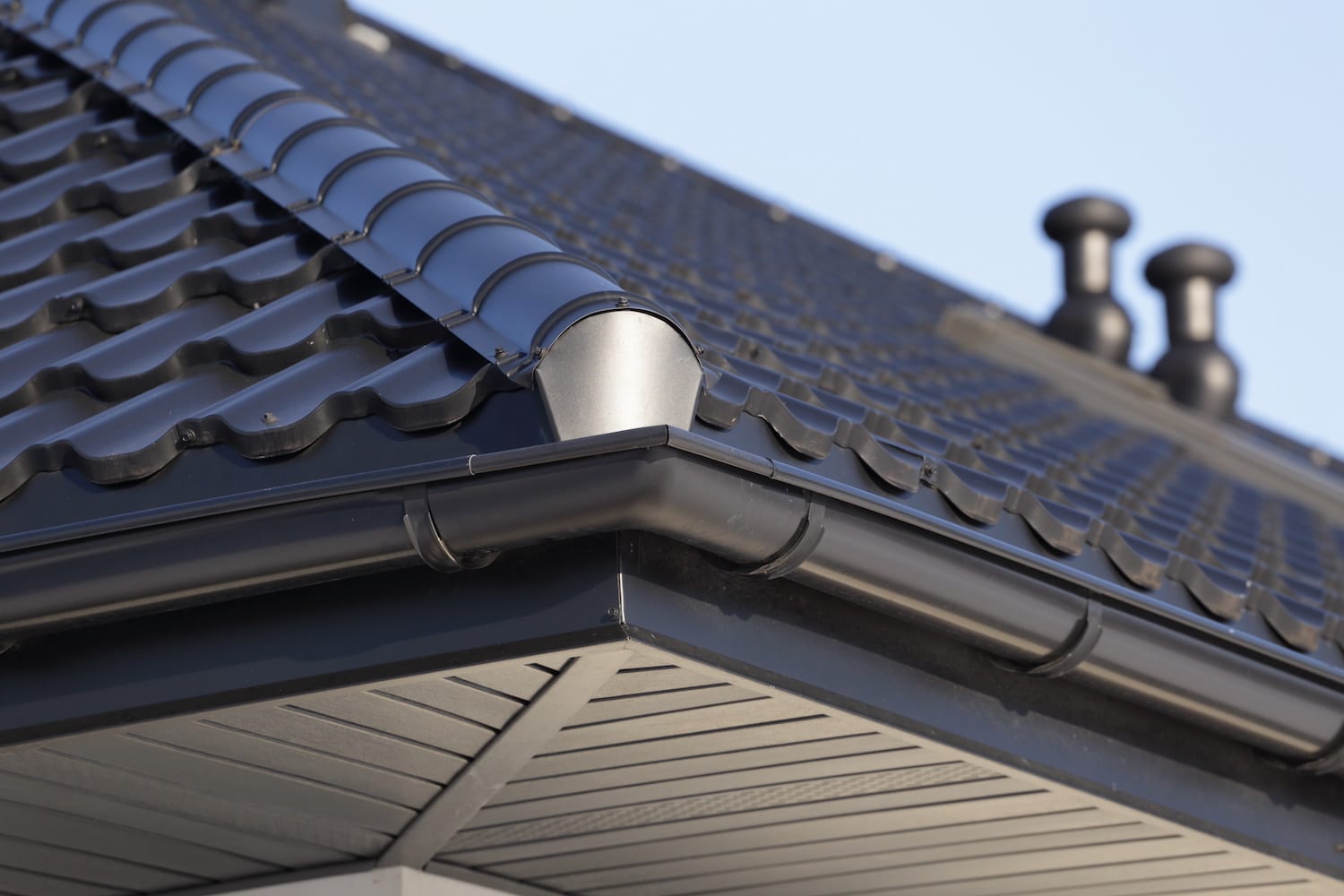 Corner of the new modern house with gutter and ventilation chimneys. how to measure for a metal roof tips and tricks