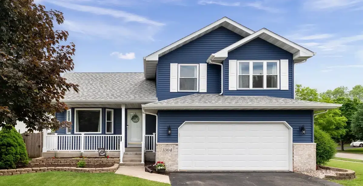front view of improved home with new grey roof