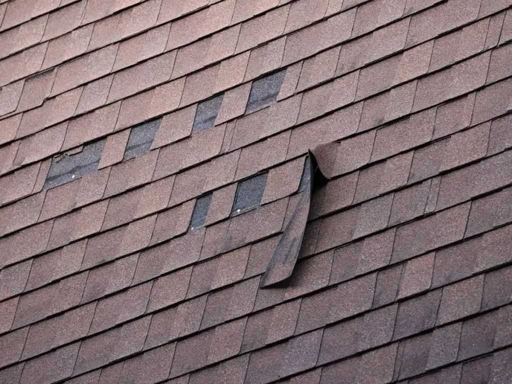 close up of missing shingles on aged roof