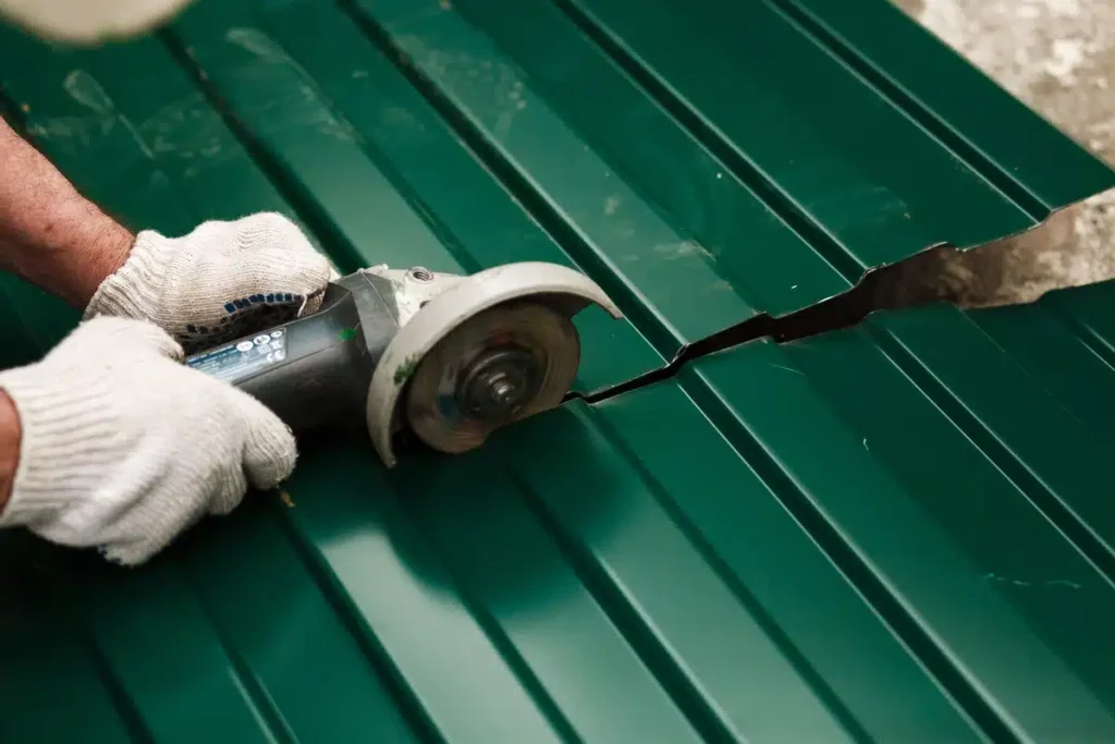 professional using special drill to cut metal roofing sheet