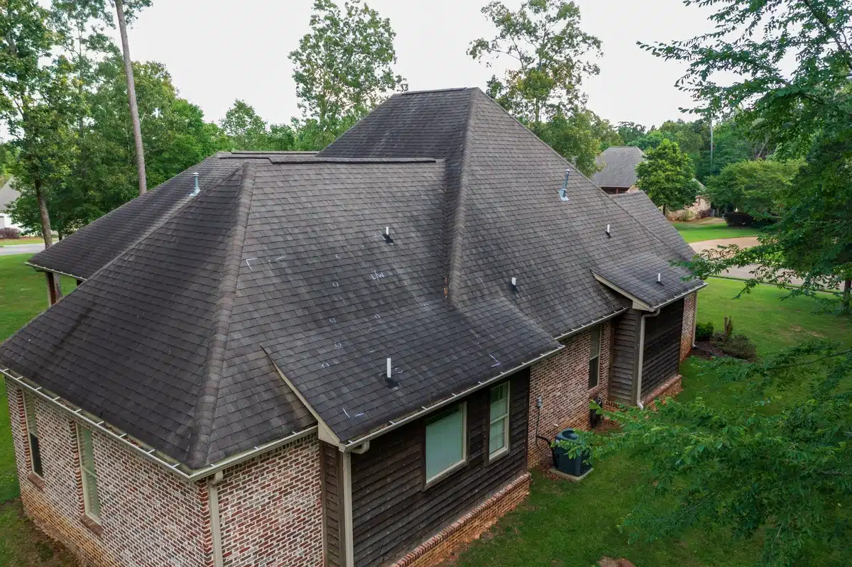 hail-damage-marks-from-inspection aged house roof with hail damage marks