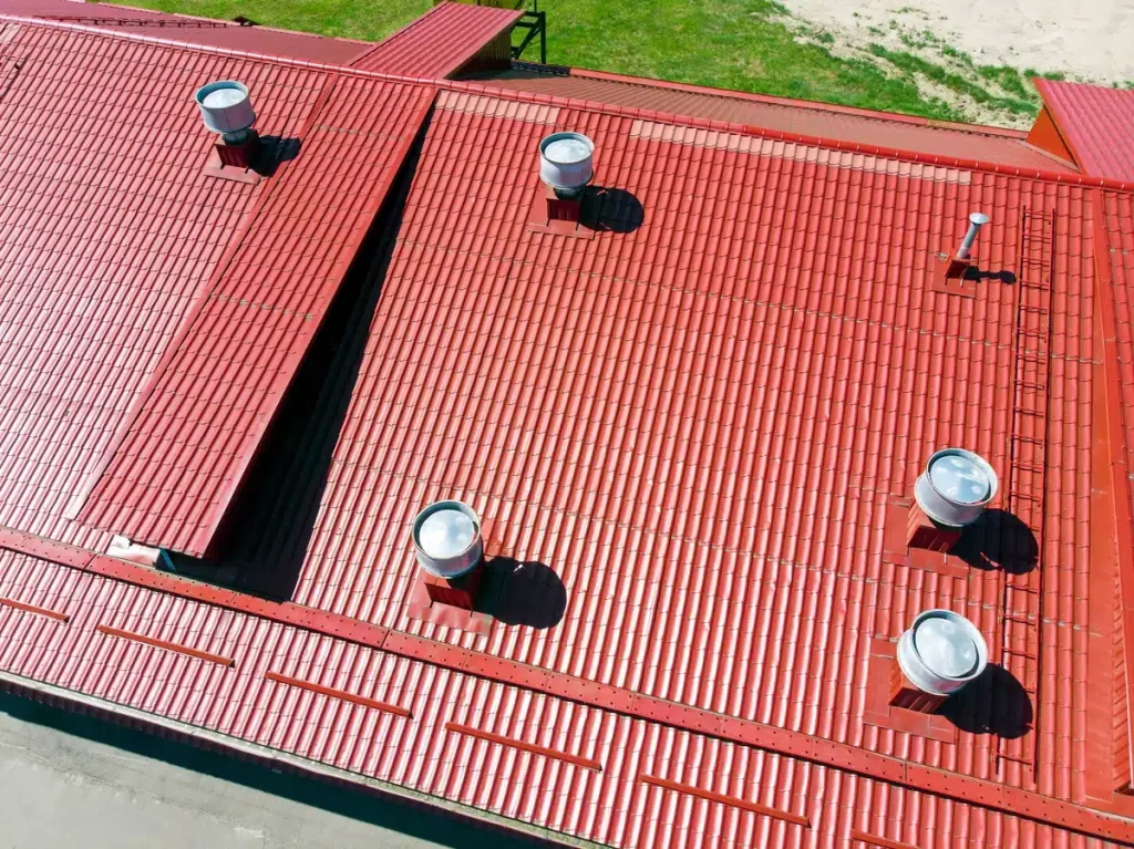 red metal roof with several roof vents