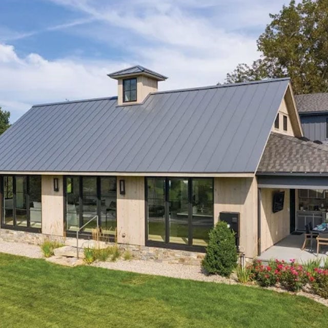 Metal roof above a glass-fronted building