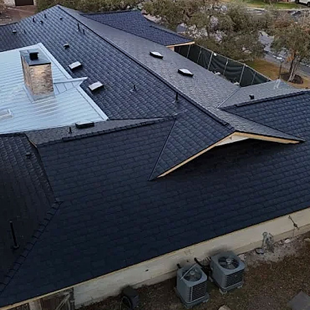 Dark roof with a metal accent and roof vents