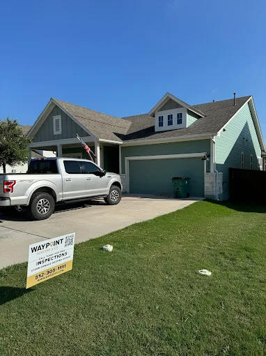 Shingle-roof home with Waypoint Roofing yard sign