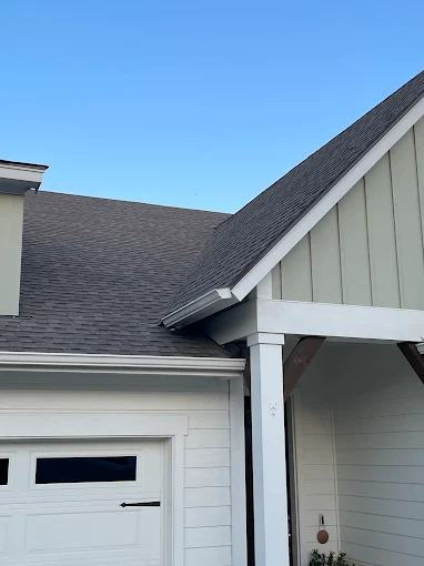 Shingle roof and gutter detail above a garage