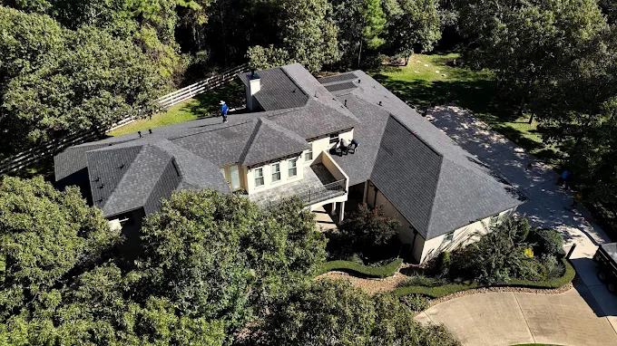 Wide aerial view of a shingle roofing project