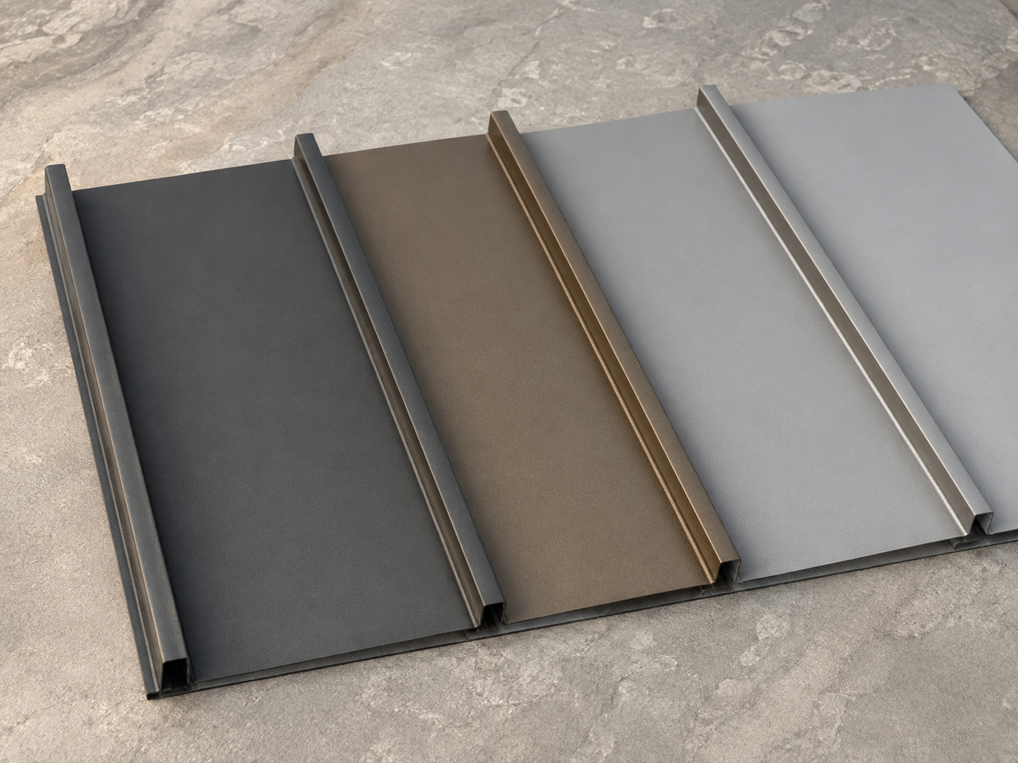 Metal roofing panel samples in charcoal, bronze and gray