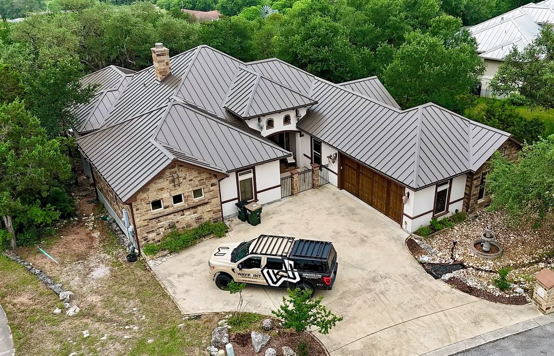 Standing-seam metal roofing project with Waypoint truck