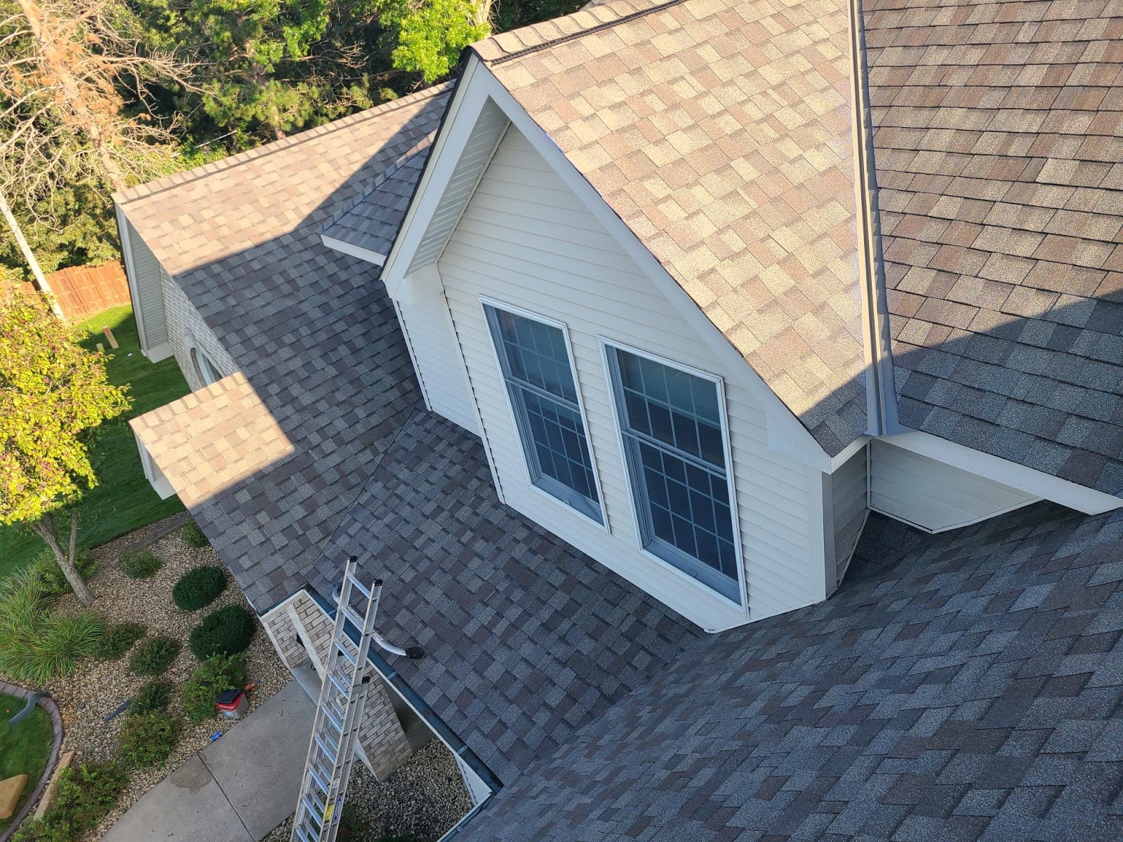 Level Edge shingle roof around a white dormer; illustrative roof style